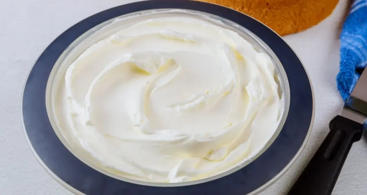 Puszysta bita śmietana z mascarpone w misce, gotowa do dekorowania biszkoptów.