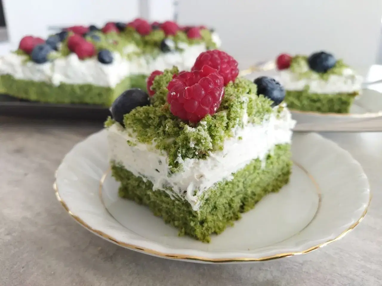 Pyszne ciasto leśny mech na dużą blachę z serkiem mascarpone, udekorowane malinami i borówkami.