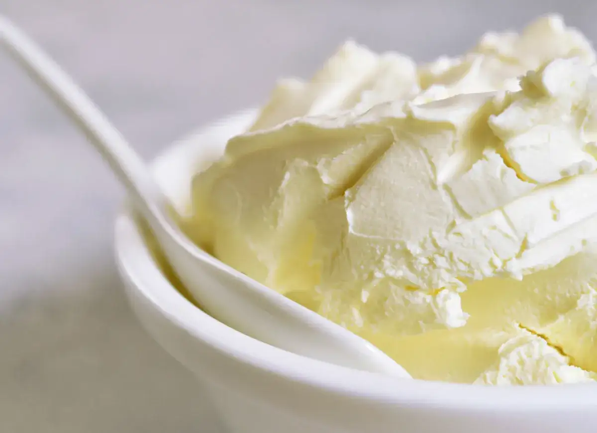 Kremowa masa w białej miseczce, idealna jako zamiennik mascarpone do deserów.