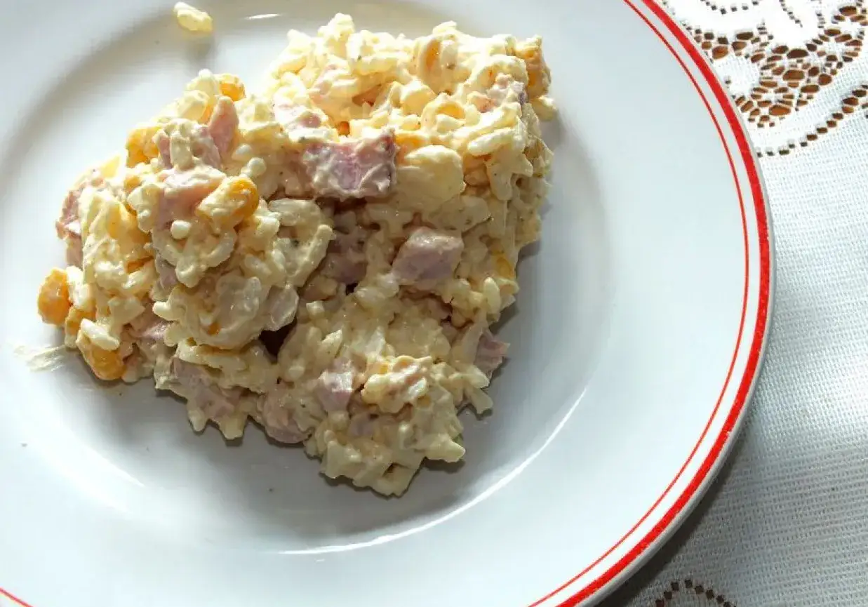 Pyszna sałatka z wędzonym kurczakiem i ryżem, z dodatkiem kukurydzy, wymieszana z kremowym sosem. Idealna na szybki lunch.